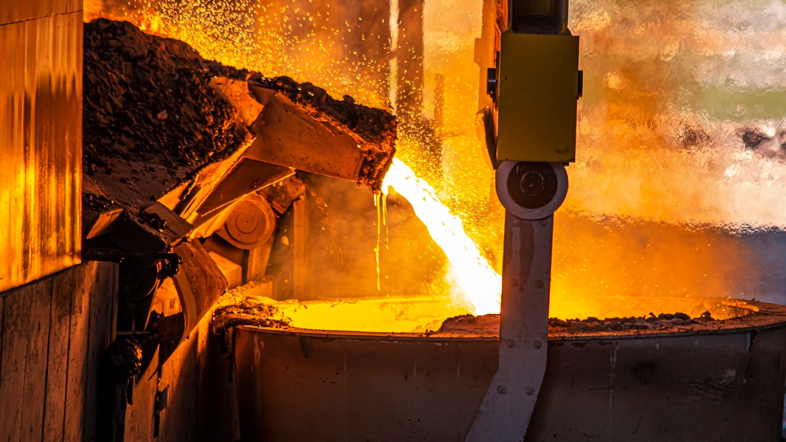 Molten metal pouring in a foundry with sparks