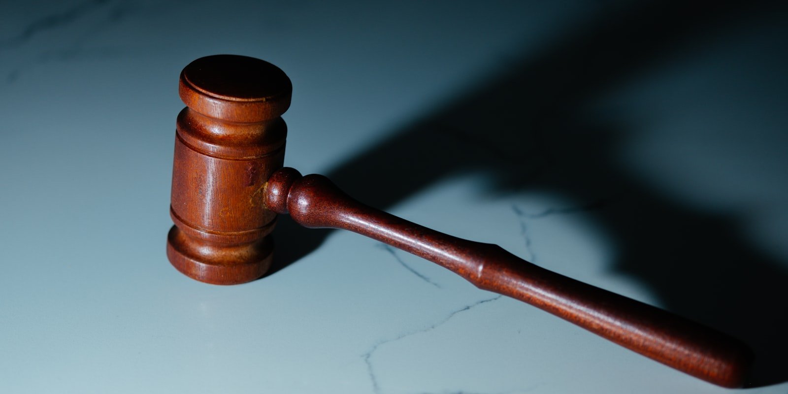 Wooden gavel resting on a marble surface